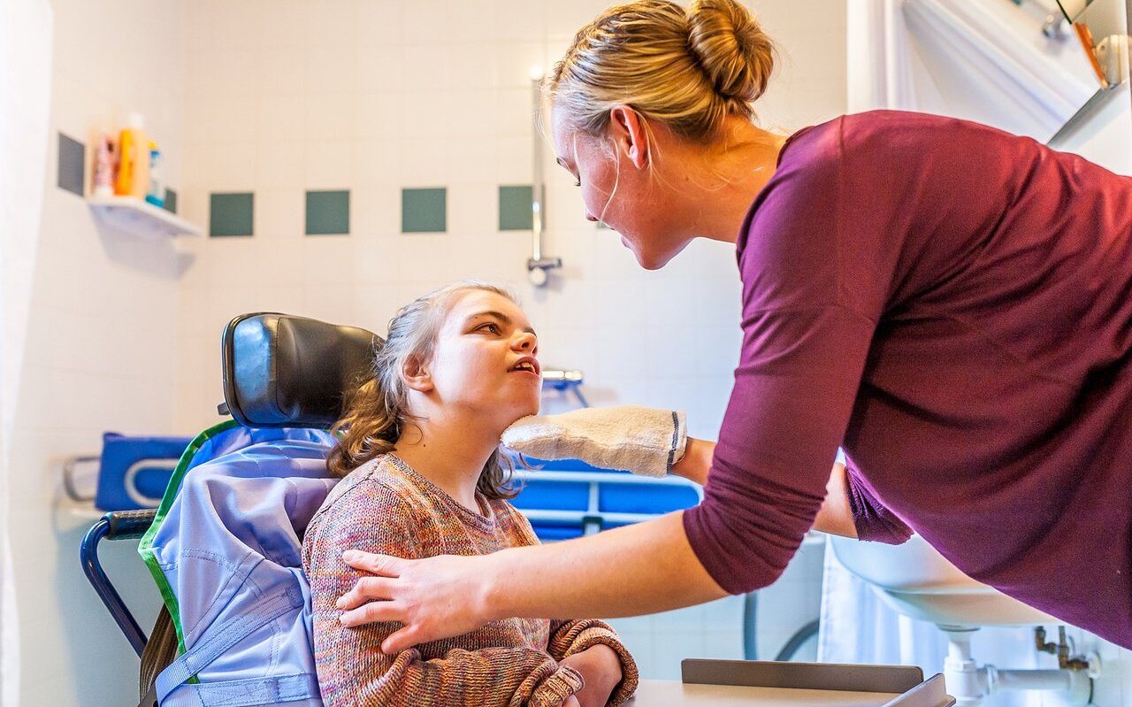 Disability a disabled child being cared for by a nurse / Disabil