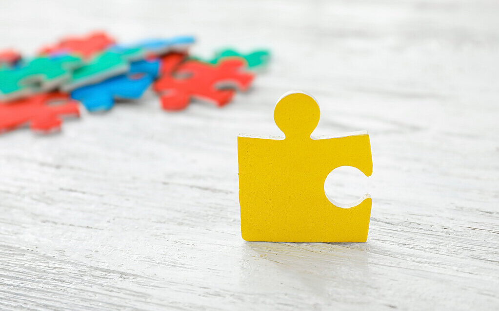 Color puzzle on wooden background